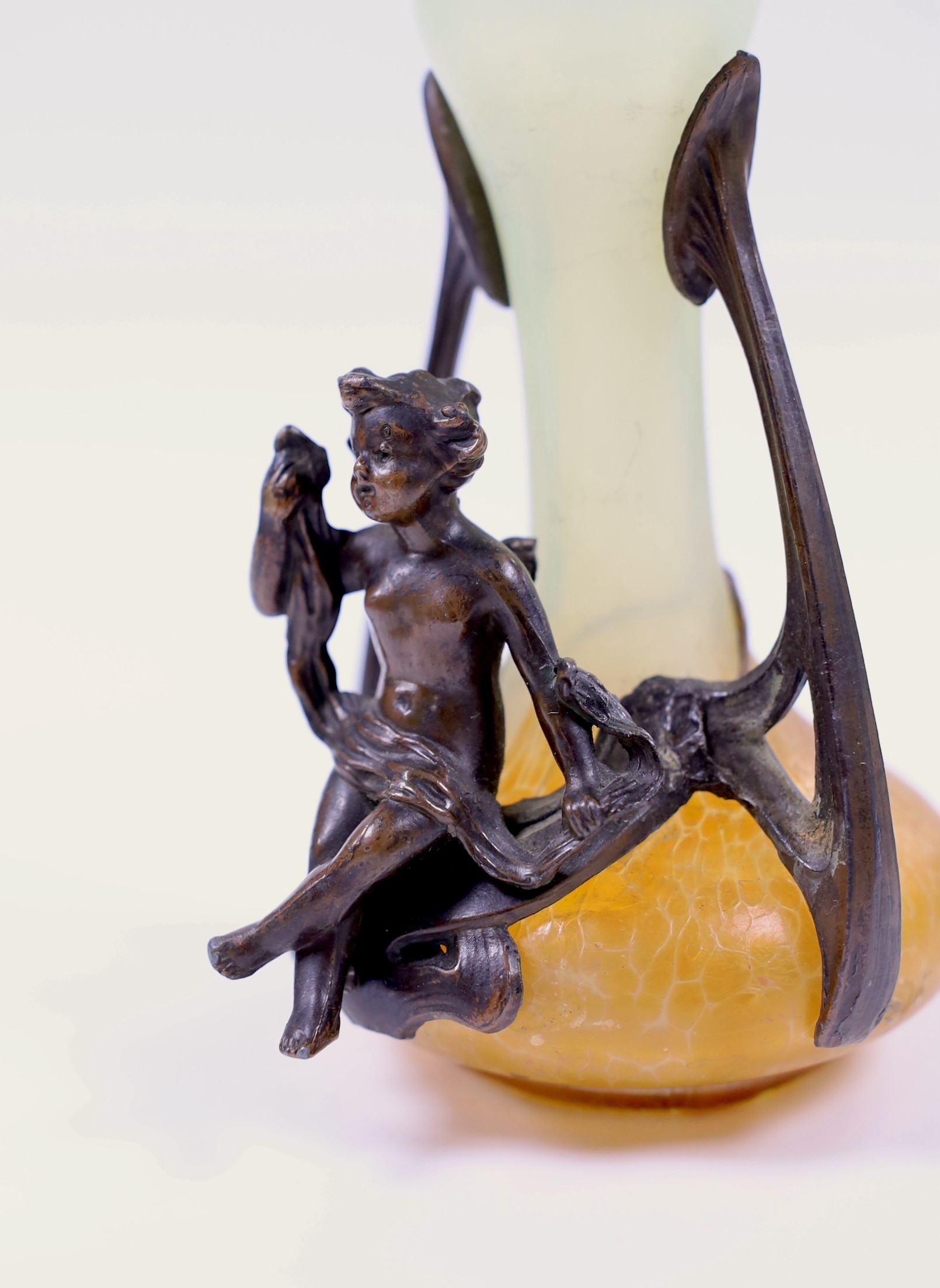 A small Art Nouveau glass vase with bronze mount and seated cherub, 16cm tall